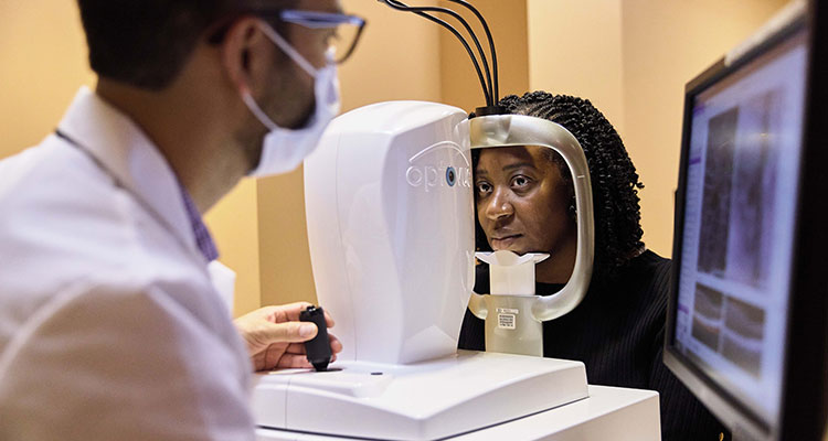 doctor checking patient's eyes